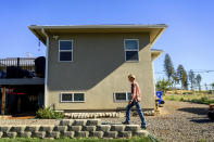 Heidi Lange walks behind her Paradise, Calif., home, Thursday, Oct. 26, 2023. Lange, who rebuilt following the Camp Fire, is facing a homeowners insurance quote that jumped from $1,191 to $9,754. (AP Photo/Noah Berger)