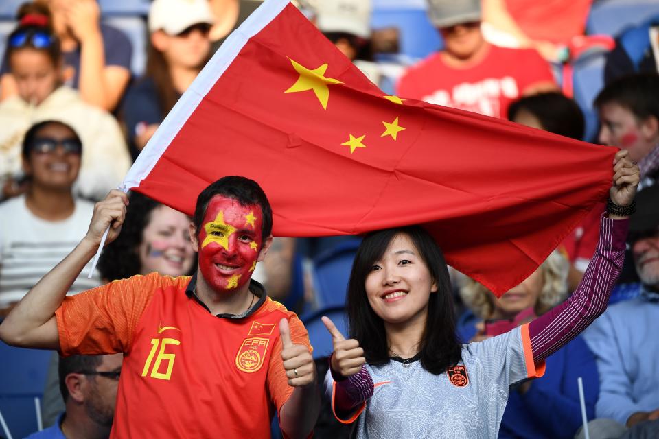 China's supporters hold China's national flag ahead of the France 2019 Women's World Cup Group B football match between South Africa and China, on June 13, 2019, at the Parc des Princes stadium in Paris. (Photo by Franck Fife/AFP/Getty Images)