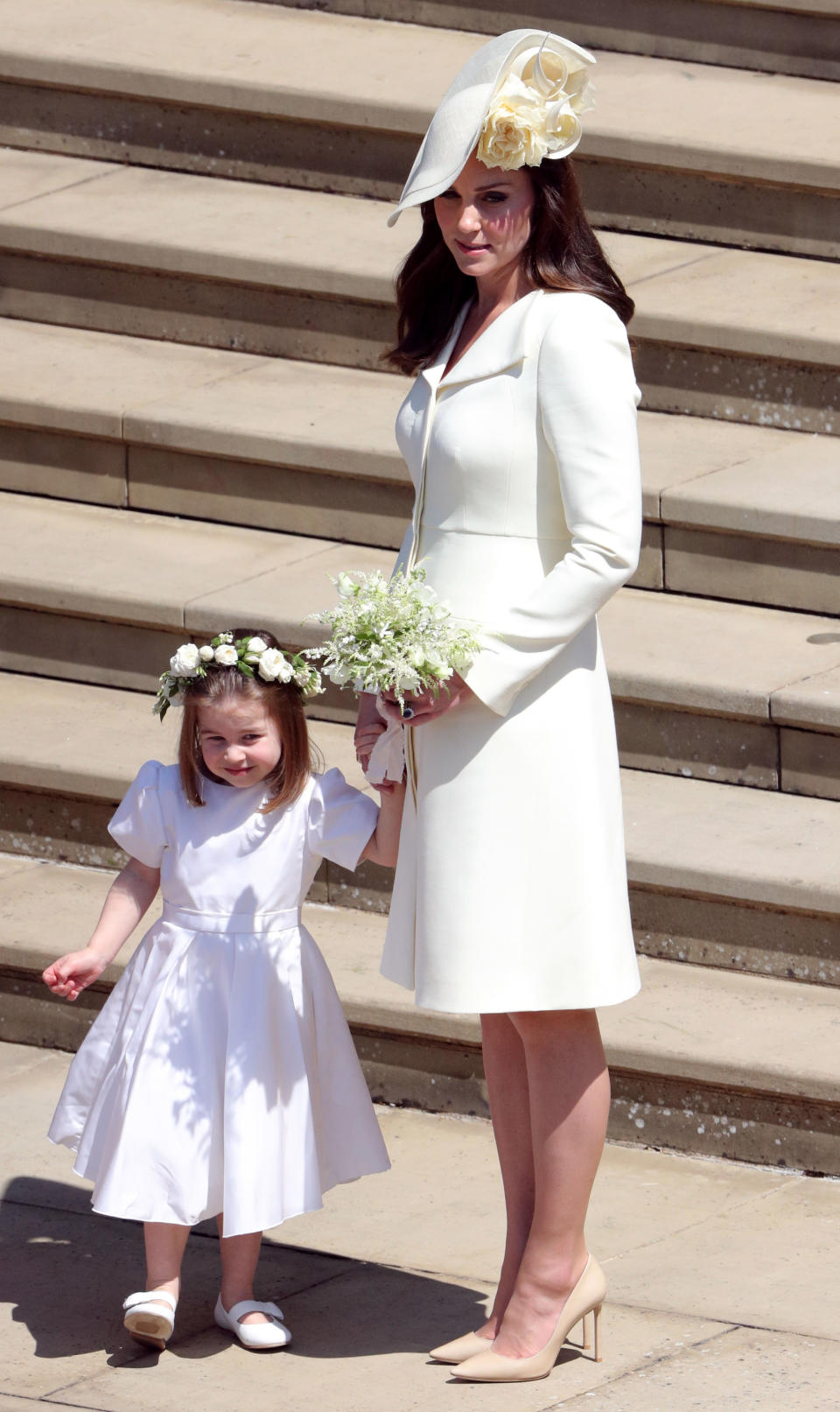 <p>For the Duke and Duchess of Sussex’s royal nuptials, the Duchess of Cambridge wore a primrose yellow coat dress by Alexander McQueen. She first donned the look at Princess Charlotte’s christening in white. <em>[Photo: Getty]</em> </p>