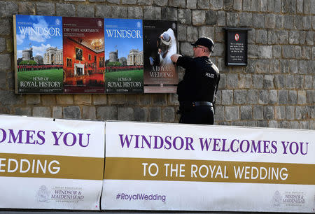 A police officer makes security checks around the castle, on the day before the royal wedding of Britain's Princess Eugenie and Jack Brooksbank, in Windsor, Britain, October 11, 2018. REUTERS/Toby Melville