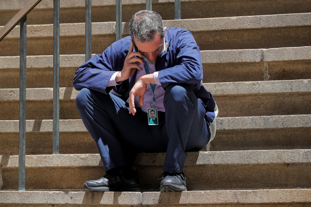 Trader Greg Rowe talks on his phone during a break outside of the New York Stock Exchange (NYSE) on Wall Street in New York City, U.S., June 16, 2021.  REUTERS/Brendan McDermid