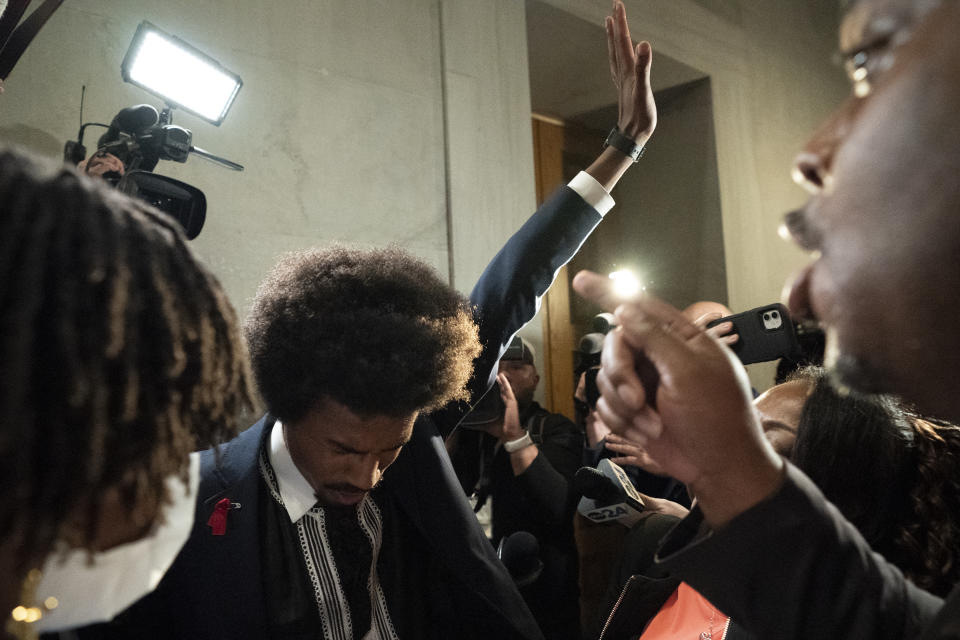 Former Rep. Justin Pearson, D-Memphis, becomes emotional with family after being expelled from the legislature outside the House chamber on Thursday, April 6, 2023, in Nashville, Tenn. Tennessee Republicans expelled two House Democrats including Pearson for using a bullhorn to shout support for pro-gun control protesters in the House chamber. (AP Photo/George Walker IV)