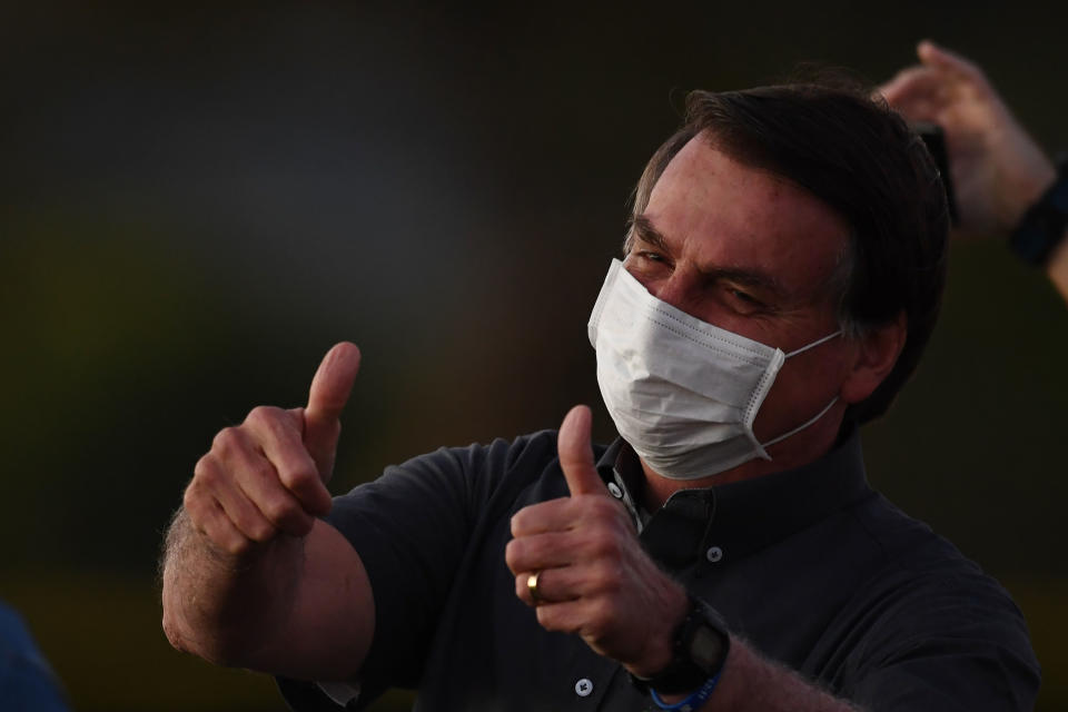 Brazilian President Jair Bolsonaro gives the thumbs up to supporters.