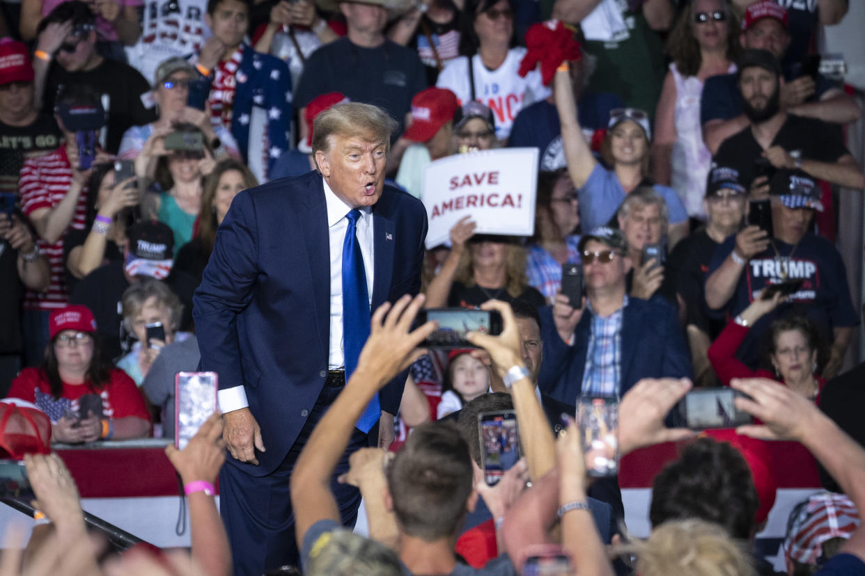 Former President Donald Trump exits the stage after speaking at a rally. 