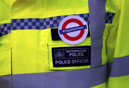 A police officer wears a sticker following the recent attack in Westminster, London, Britain March 24, 2017. REUTERS/Peter Nicholls