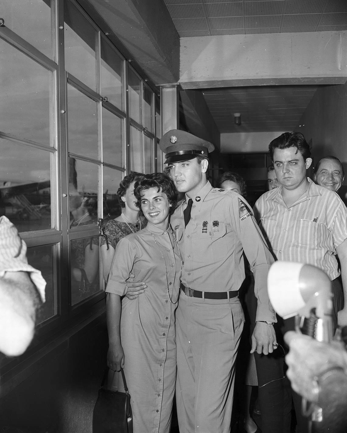 June 14, 1958: Pvt. Elvis Presley, traveling from Memphis back to Fort Hood, Texas, stops over at Amon Carter Airfield. He poses for a picture with Nancy Cathcart.