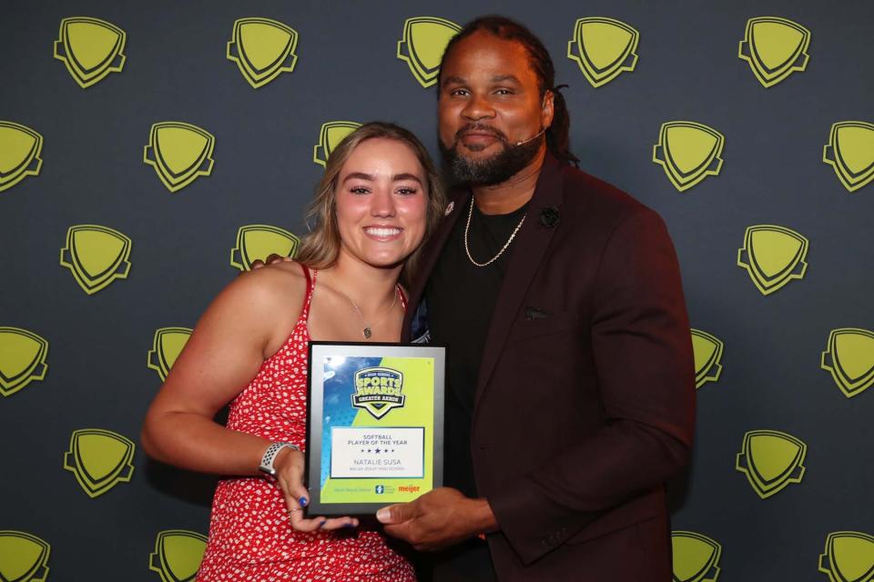 Natalie Susa, left, of Walsh Jesuit and Greater Akron Softball Player of the Year, poses with Josh Cribbs at the Greater Akron and Portage County Sports Awards on Friday night at the Civic Theatre in Akron. 