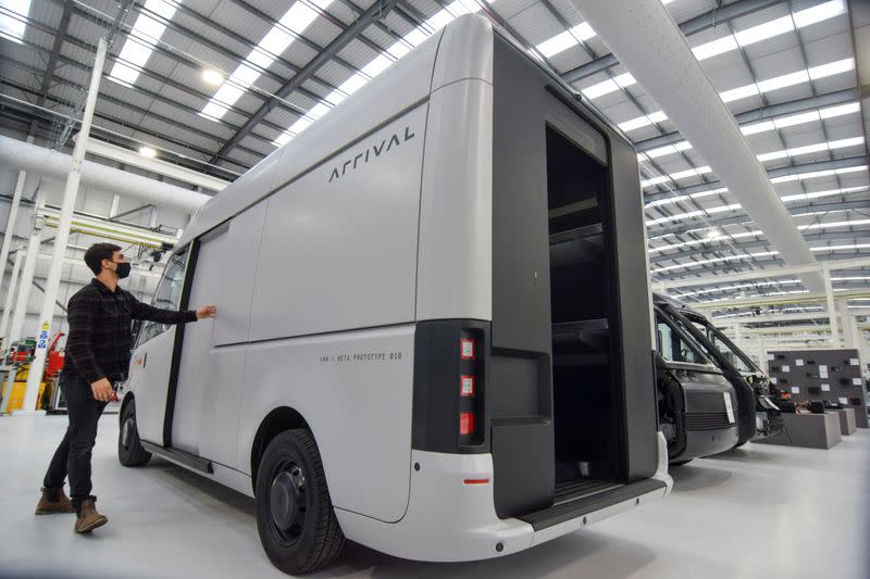 A man looks at a fully-electric test van, due to go into production in 2022, in Banbury