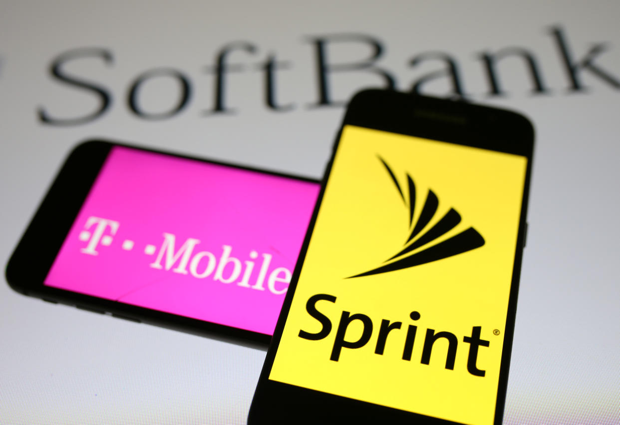 Smartphones with the logos of T-Mobile and Sprint are seen in front of a Soft Bank logo in this illustration taken September 19, 2017. REUTERS/Dado Ruvic/Illustrations