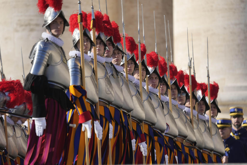 Swiss guards stand at the attention prior to the start of Pope Francis Urbi et Orbi (Latin for 'to the city and to the world' ) Christmas' day blessing at the Vatican, Sunday, Dec. 25, 2022. (AP Photo/Gregorio Borgia)