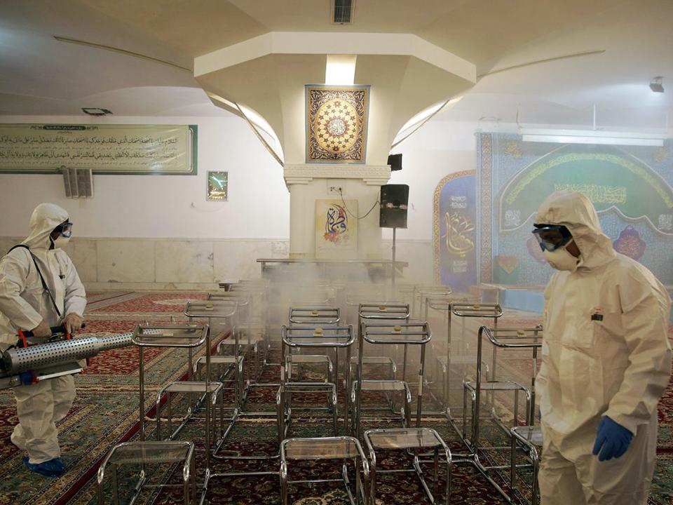 Members of the medical team spray disinfectant to sanitize indoor place of Imam Reza's holy shrine, following the coronavirus outbreak, in Mashhad, Iran February 27, 2020. .JPG
