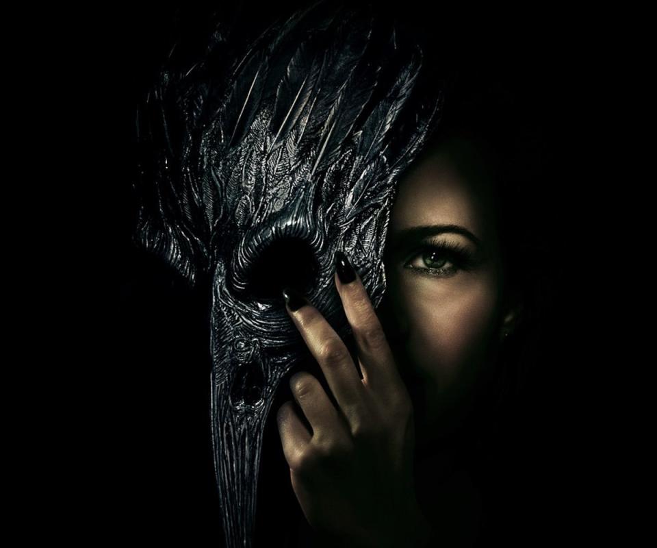 A poster of a woman with half a raven mask covering her face for The Fall of the House of Usher