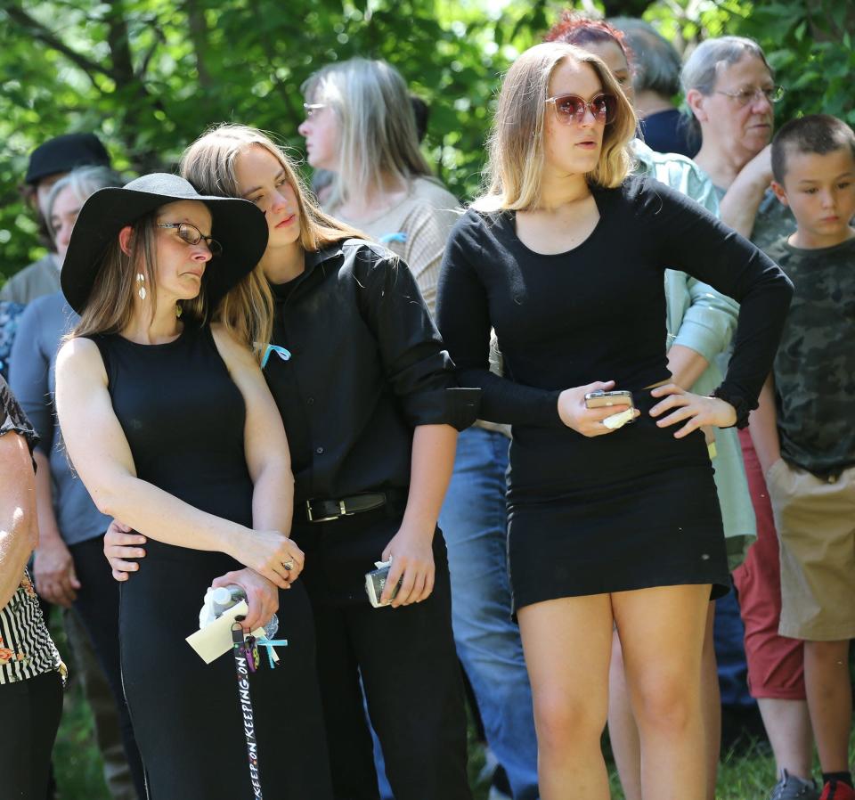 Kristina Foster, left, Curtis Cole's partner of 24 years, is seen with their daughters Isabella Cole, center, and  Joselyn Cole, during his funeral service Sunday, June 12, 2022, at Cold Springs Cemetery in East Rochester.