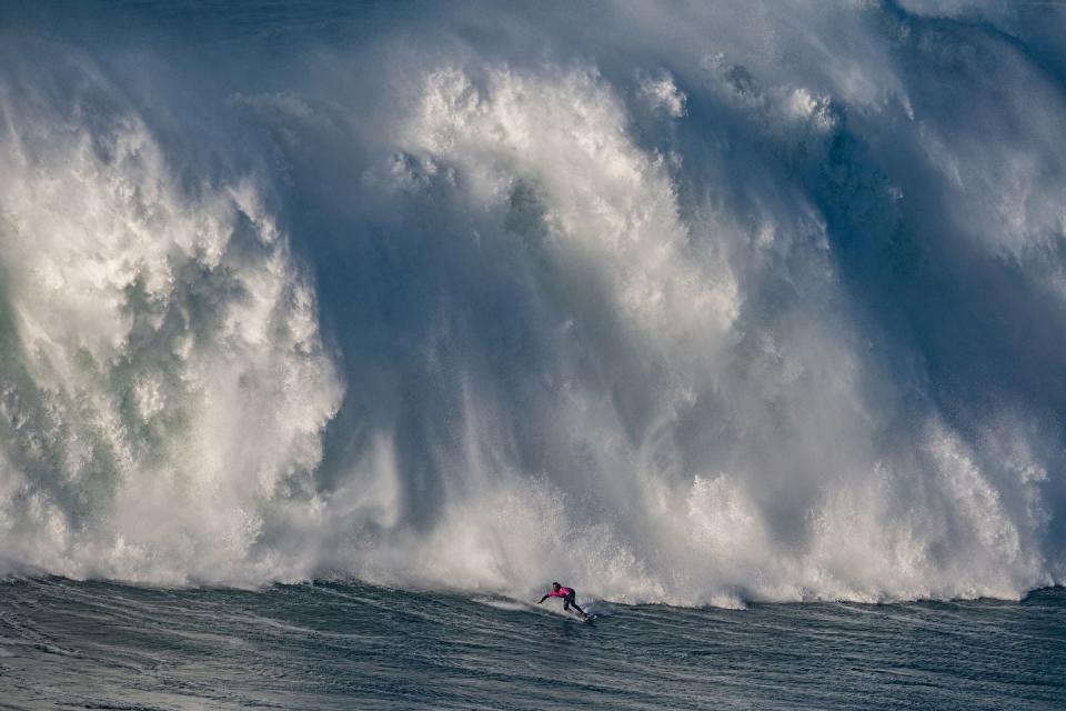 nazare, portugal december 13 a big wave surfer kealii mamala from hawaii rides a wave during the tudor nazare tow surfing challenge at praia do norte on december 13, 2021 in nazare, portugal photo by octavio passosgetty images