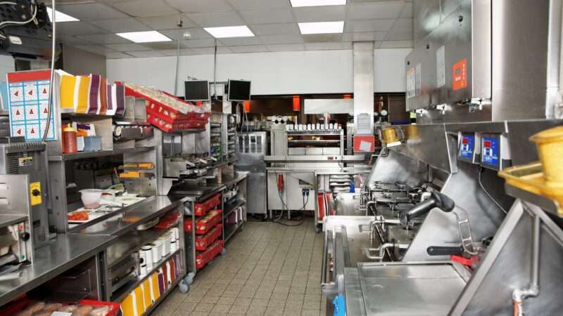 Commercial kitchen in a fast food restaurant, clean and empty as if untouched.