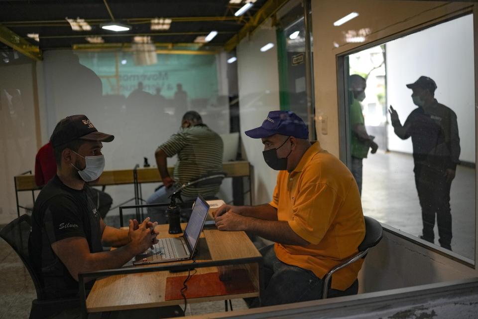 A driver is interviewed at Ridery headquarters in Caracas, Venezuela, Wednesday, May 4, 2022. Ridery is one of at least three Venezuelan ride-sharing apps that launched during the pandemic — and which have taken advantage of a de facto switch of currencies from the Venezuelan bolivar to the U.S. dollar. (AP Photo/Matias Delacroix)