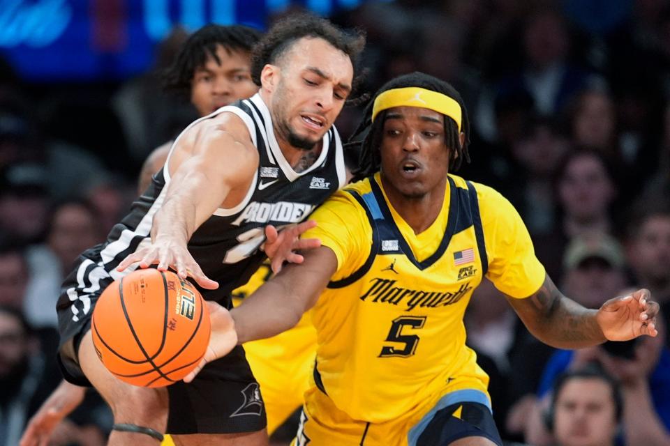 Devin Carter, left, and the Providence Friars have at least one more game to play. PC was selected to play in the NIT and will face New England rival Boston College.