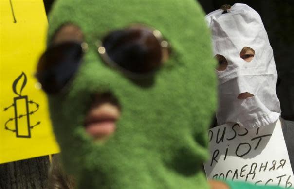 People wearing trademark Pussy Riot balaclavas attend a support rally for the detained members of the Moscow based feminist punk band outside the Russian embassy in Berlin, August 17, 2012. The placard reads: "Pussy Riot: Russia's last conscience."