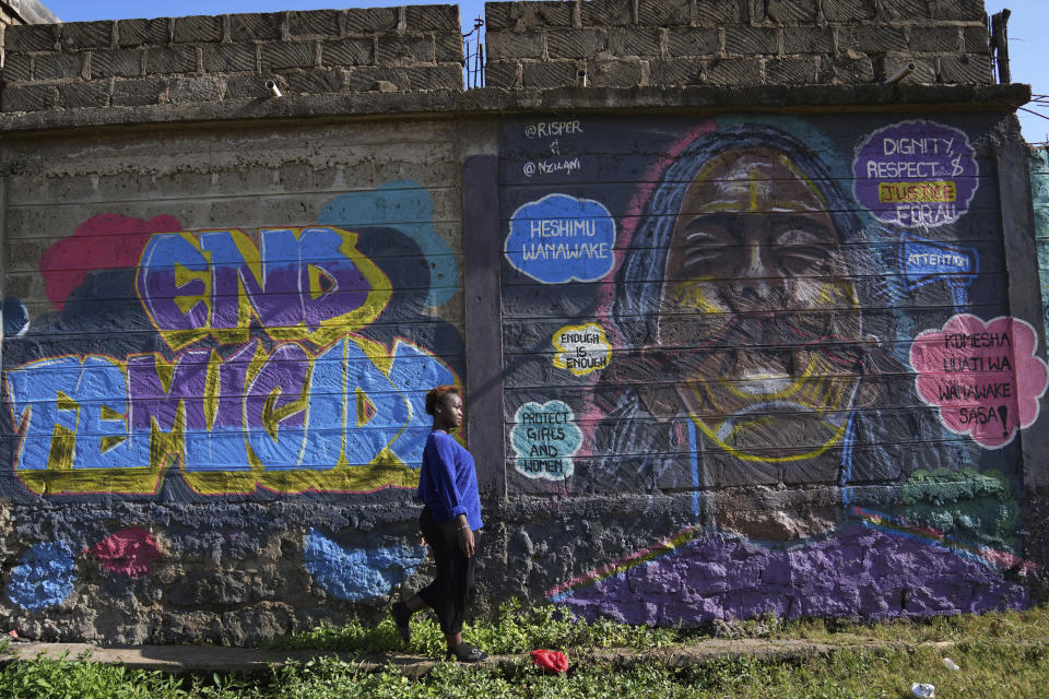 A woman walks past an informational mural against gender based violence, on a street, in Nairobi, Kenya, Wednesday, March 6, 2024. Globally, one in three women experiences either intimate partner violence or non-partner sexual violence during their lifetime, according to the World Health Organization. (AP Photo/Brian Inganga)