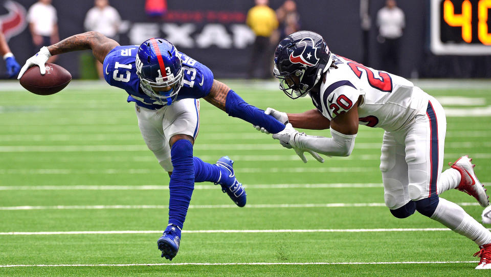 <p>Houston Texans defensive back Justin Reid (20) grabs the arm of New York Giants wide receiver Odell Beckham Jr. (13) during the first half of an NFL football game Sunday, Sept. 23, 2018, in Houston. (AP Photo/Eric Christian Smith) </p>