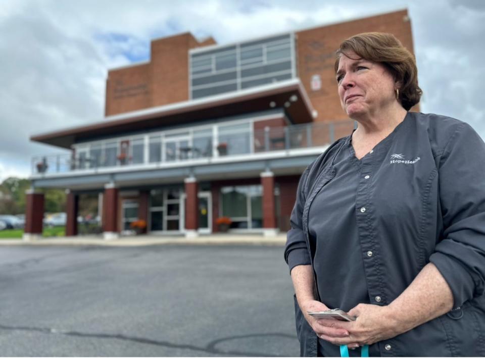 Virginia Magnan, clinical director of the HopeHealth Hulitar Hospice Center, stands in front of the building on Providence's North Main Street.