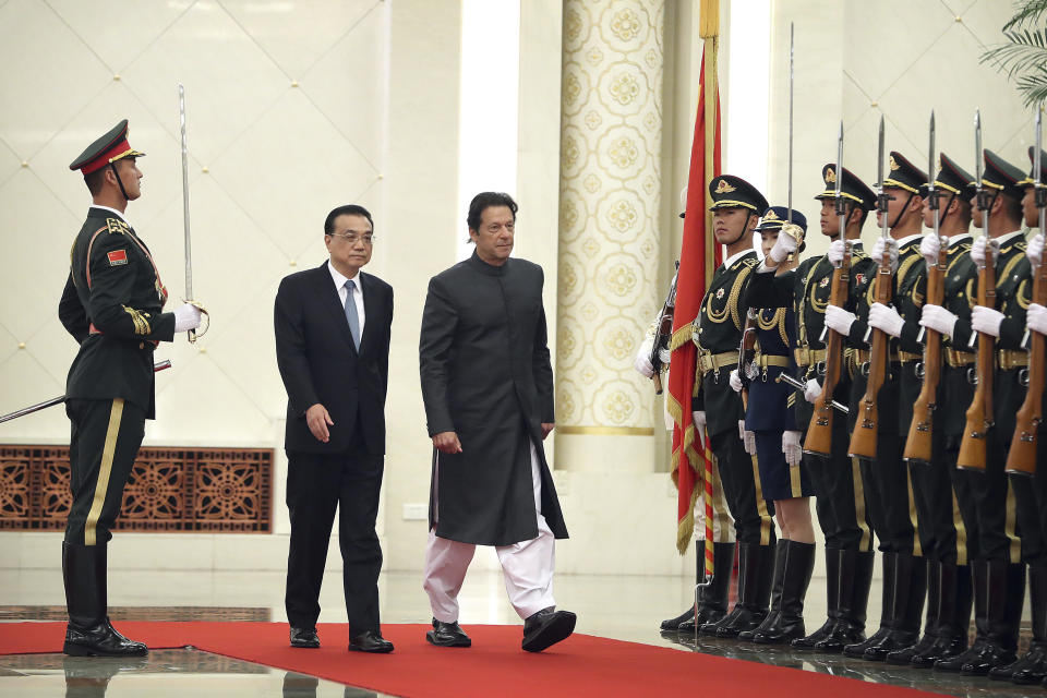 Chinese Premier Li Keqiang, left, and Pakistan's Prime Minister Imran Khan review an honor guard during a welcome ceremony at the Great Hall of the People in Beijing, Saturday, Nov. 3, 2018. (AP Photo/Mark Schiefelbein)
