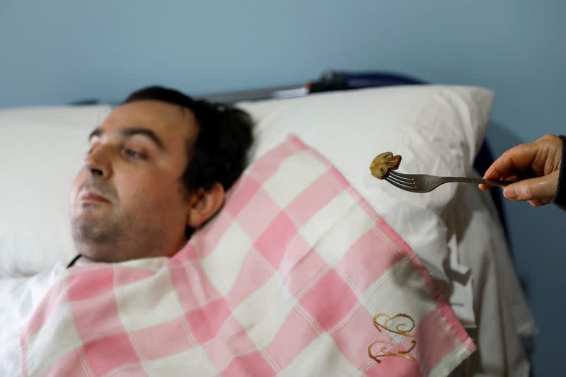 Rafael Botella, 35, tetraplegic since he was 19 after a car crash where his girlfriend died, is fed by his mother Maria Luisa, 73, at his home in Simat de la Valldigna