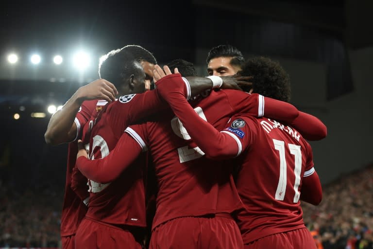 Liverpool players surround Philippe Coutinho after he scored their second goal during their match against Spartak Moscow in Liverpool, north-west England on December 6, 2017