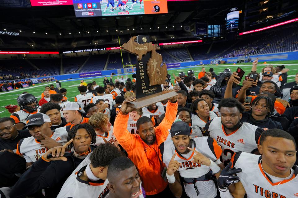Belleville celebrates after Belleville's 55-33 win over Rochester Adams in the Division 1 football state final on Saturday Nov, 27, 2021, at Ford Field.