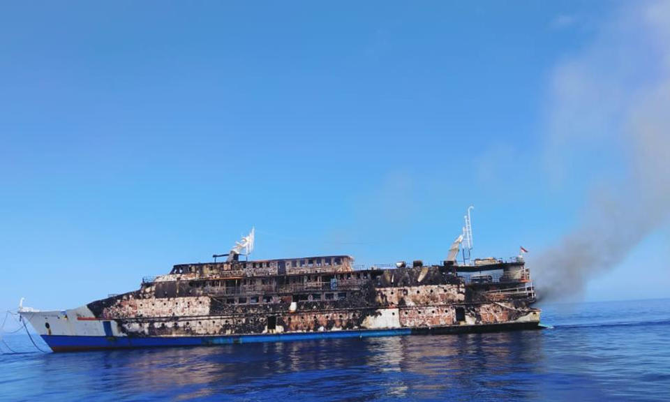 This Saturday, May 29, 2021, photo released by the National Search and Rescue Agency (BASARNAS), smoke billows from the wreckage of KM Karya Indah ferry after it caught fire off Limafatola Island, Indonesia. The ferry in eastern Indonesia caught fire early Saturday with nearly 200 people on board, forcing passengers and crew to jump into the sea but causing no casualties, officials said. (BASARNAS via AP)