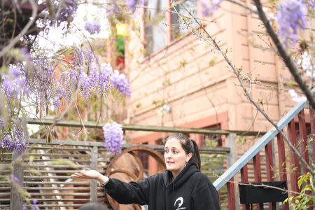 Joy Ashe gestures to a building under renovation outside her home in Emeryville, California, United States March 20, 2017. Ashe, who has spoken before the city's planning commission and city council, is concerned about lead and other pollutants from the construction affecting her family. To match Special Report USA-LEAD/CALIFORNIA REUTERS/Noah Berger