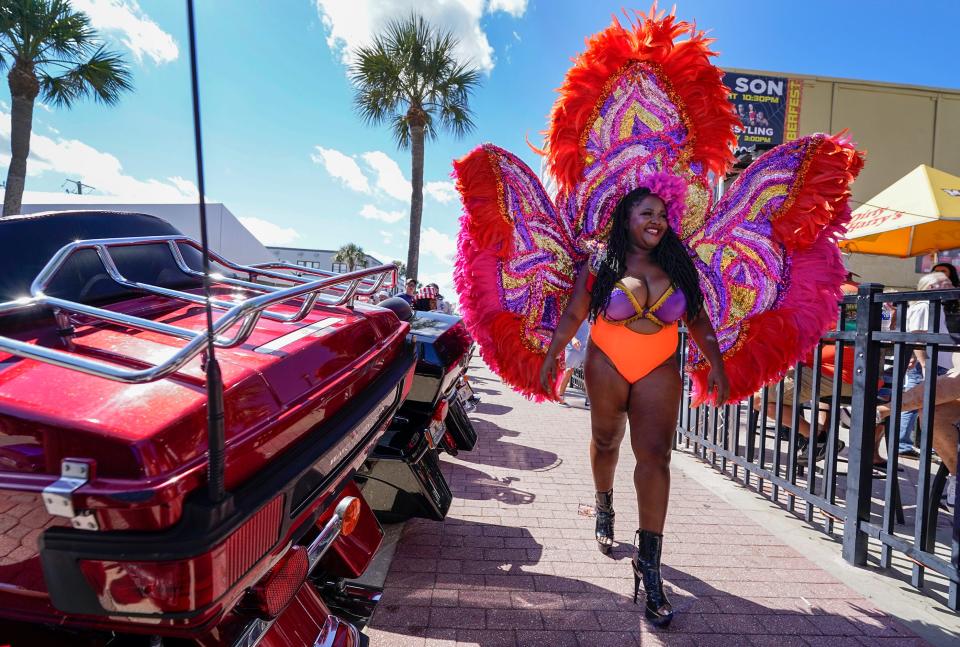 Misty Rose struts down Main Street on Friday advertising a burlesque show as Biketoberfest rolls toward the weekend in Daytona Beach. There were plenty of colorful characters and custom machines to see at the event that runs throufh Sunday in Daytona Beach.