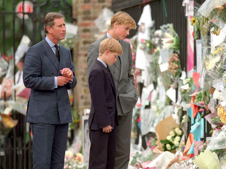 King Charles III, Prince William, and Prince Harry look at floral tributes for Princess Diana in 1997.