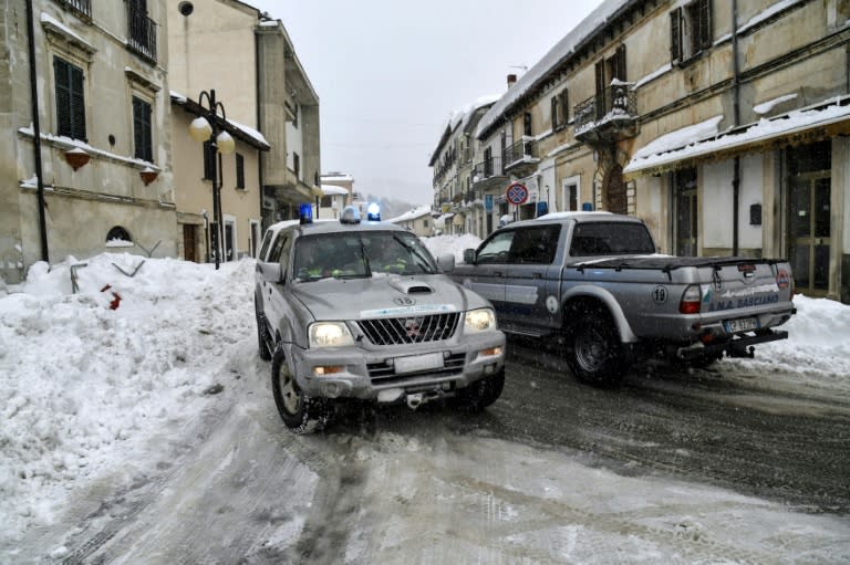 Rescuers drive through the streets of Montereale after fresh earthquakes struck central Italy on January 18, 2017