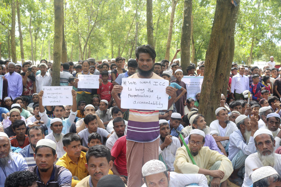 Rohingya refugees hold placards as they gather to mark the fifth anniversary of their exodus from Myanmar to Bangladesh, at a Kutupalong Rohingya refugee camp at Ukhiya in Cox's Bazar district, Bangladesh, Thursday, Aug. 25, 2022. Hundreds of thousands of Rohingya refugees on Thursday marked the fifth anniversary of their exodus from Myanmar to Bangladesh, while the United States, European Union and other Western nations pledged to continue supporting the refugees' pursuit of justice in international courts.(AP Photo/ Shafiqur Rahman)