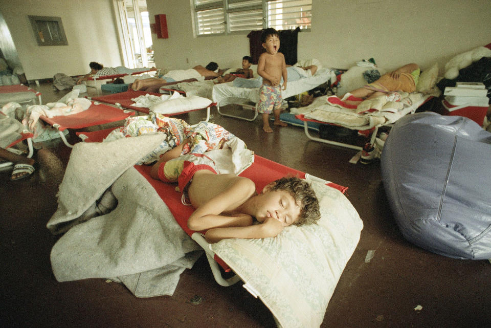 <p>Jesus Cruz, 7, sleeps on a cot at a Red Cross shelter in Homestead, Fla., Aug. 29, 1992. His family had saved their money for years to buy a home in nearby Florida City only 3 months ago but they lost everything they had when Hurricane Andrew devastated the area last Monday. (AP Photo/Rick Bowmer) </p>