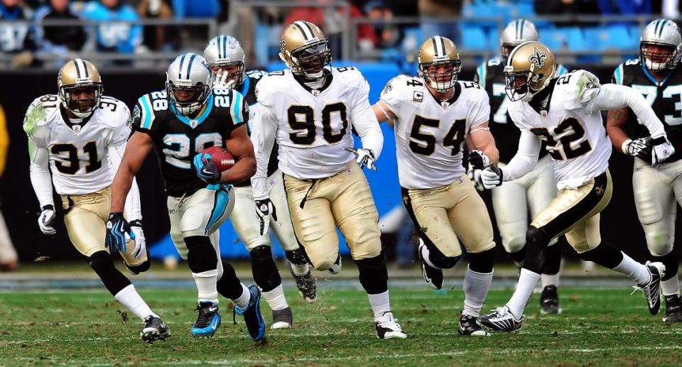 Carolina Panthers running back (28) Jonathan Stewart breaks away from a host of New Orleans Saints in a game on Jan. 3, 2010. Stewart would finish his career with the Panthers as the team’s all-time leading rusher.