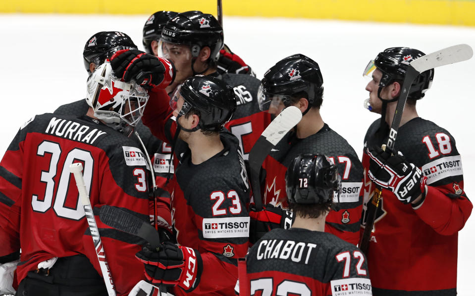 Canada players celebrate with their goaltender Matt Murray, left, at the end of the Ice Hockey World Championships semifinal match between Canada and Czech Republic at the Ondrej Nepela Arena in Bratislava, Slovakia, Saturday, May 25, 2019. Canada won 5-1. (AP Photo/Petr David Josek)