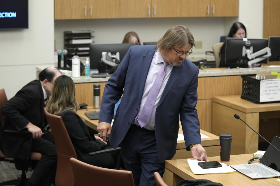 Attorney Bryan Blehm, right, representing former Arizona Republican candidate for governor Kari Lake, walks back to his desk as attorneys representing Maricopa County Joseph La Rue, left, and Rosa Aguilar speak to one another, during the second day of the two-day bench trial brought by Lake regarding a voting records request, Monday, Sept. 25, 2023, in Phoenix. (AP Photo/Ross D. Franklin, Pool)