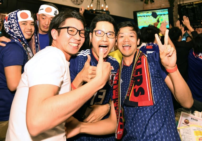 Bars across Japan erupted with joy on Tuesday as football fans exchanged beery hugs after their team stunned Colombia 2-1 in their World Cup opener in Russia