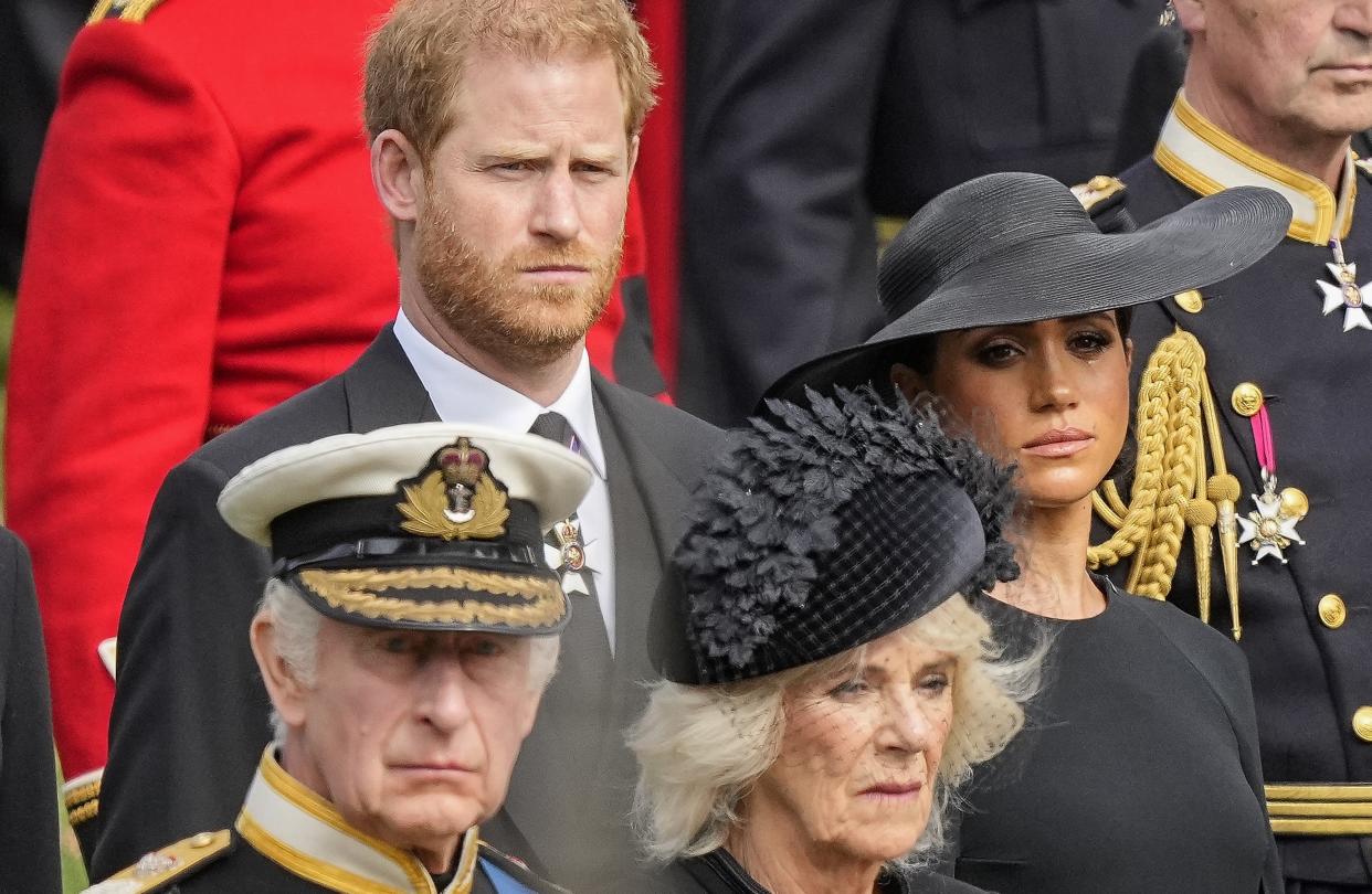 FILE - Britain's King Charles III, from bottom left, Camilla, the Queen Consort, Prince Harry and Meghan, Duchess of Sussex watch as the coffin of Queen Elizabeth II is placed into the hearse following the state funeral service in Westminster Abbey in central London Monday Sept. 19, 2022. King Charles III will hope to keep a lid on those tensions when his royally blended family joins as many as 2,800 guests for the new king’s coronation on May 6 at Westminster Abbey. All except Meghan, the Duchess of Sussex, who won’t be attending. (AP Photo/Martin Meissner, Pool, File)