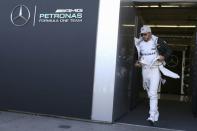 Formula One F1 - U.S. Grand Prix - Circuit of the Americas, Austin, Texas, U.S., 22/10/16. Mercedes' Lewis Hamilton of Britain holds his fire suit as he walks following the third practice session. REUTERS/Adrees Latif