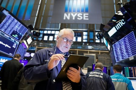 Traders work on the floor at the NYSE in New York