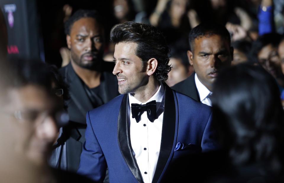 Indian film star Hrithik Roshan walks the green carpet as he arrives for the 15th annual International Indian Film Awards on Saturday, April 26, 2014, in Tampa, Fla. (AP Photo/Brian Blanco)
