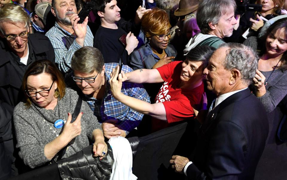 Democratic presidential candidate Mike Bloomberg poses for a photo with a supporter at his 2020 Early Vote Rally at Rocketown Wednesday, Feb. 12, 2020, in Nashville, Tenn.