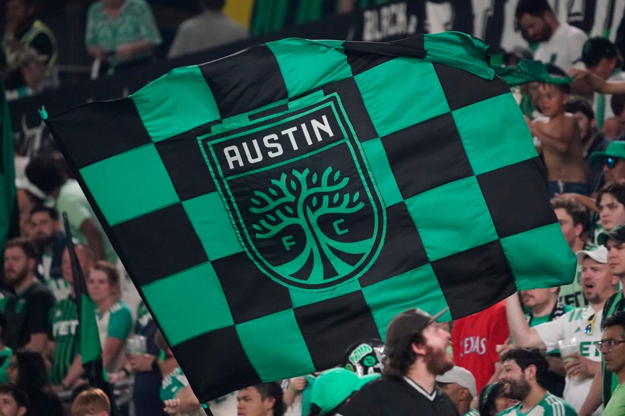 May 29, 2024;  Austin, Texas, USA;  Austin FC supporters hold flags during the second half against the Portland Timbers at Q2 Stadium.  Mandatory Credit: Scott Wachter-USA TODAY Sports