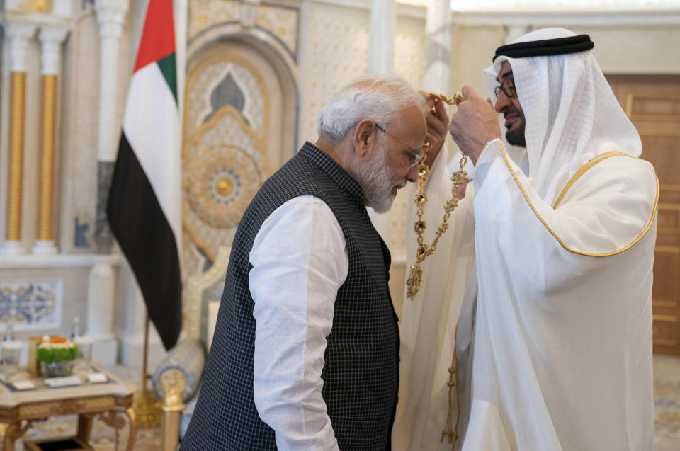 In this photograph made available by the state-run WAM news agency, Indian Prime Minister Narendra Modi, left, receives a medal during his induction to the Order of Zayed from Sheikh Mohammed bin Zayed Al Nahyan, right, in Abu Dhabi, United Arab Emirates, Saturday, Aug. 24, 2019. Modi is on a trip to both the United Arab Emirates and Bahrain, reinforcing ties between India and the Gulf Arab nations as he pursues stripping statehood from the disputed Muslim-majority region of Kashmir. (Hamad al-Kaabi - Ministry of Presidential Affairs/WAM via AP)