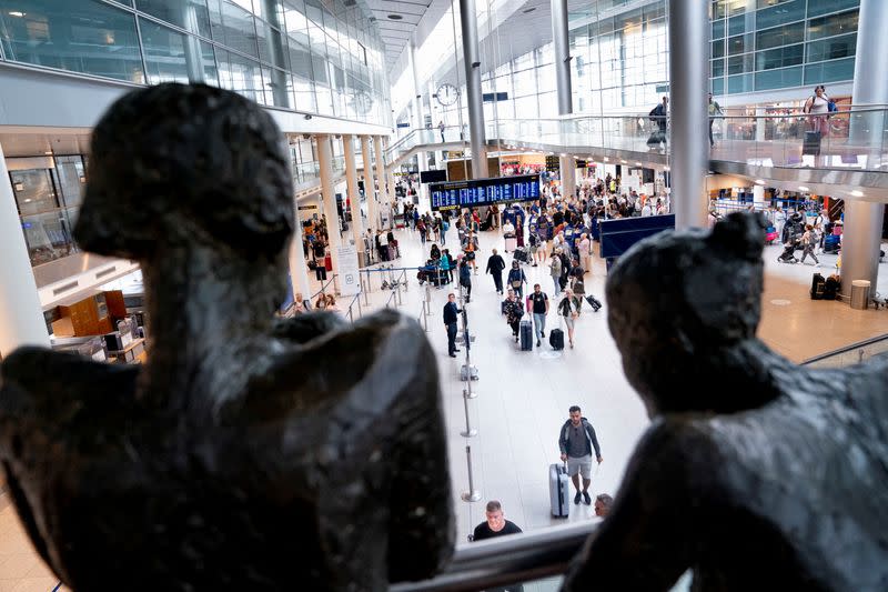 Passengers walk at the airport during a pilot strike at Copenhagen Airport