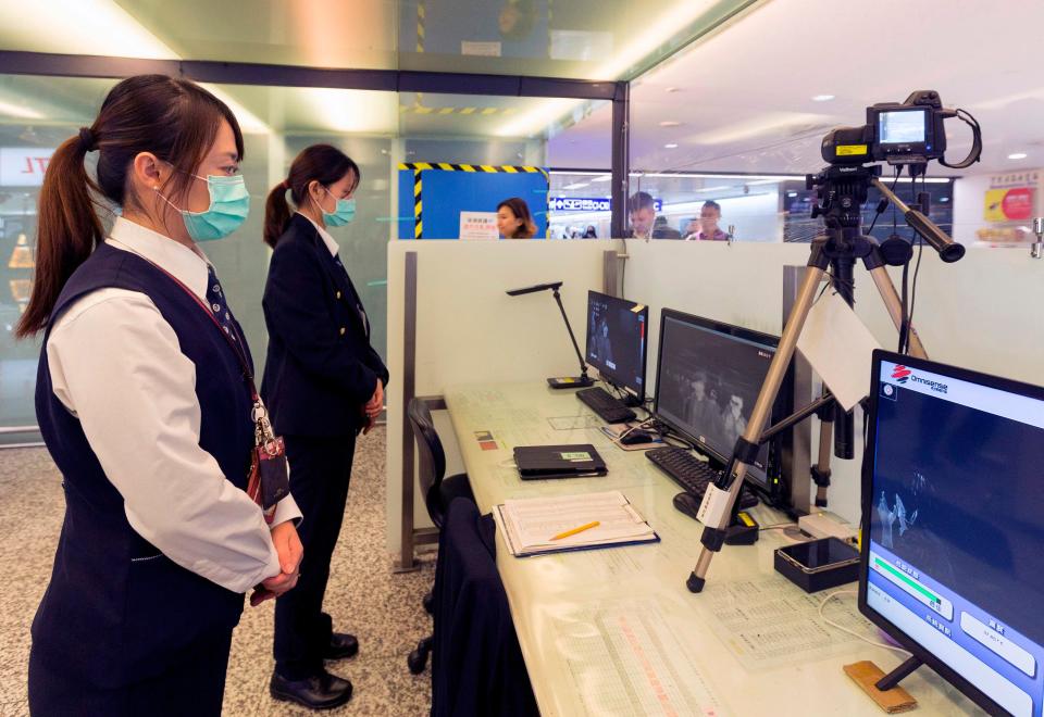 Taiwan's Center for Disease Control screens passengers arriving on a flight from Wuhan, China, in January 2020.