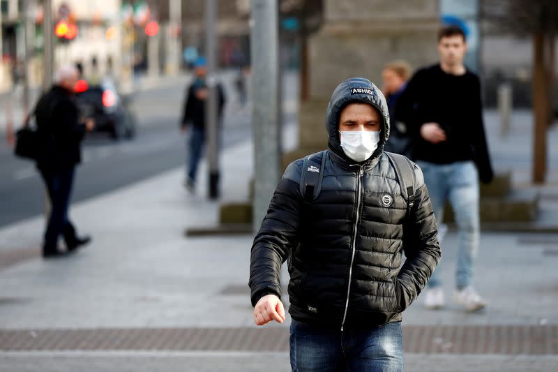 FILE PHOTO: A man wearing a face mask on St. Patrick's Day as public events were cancelled as the number of coronavirus cases grow around the world